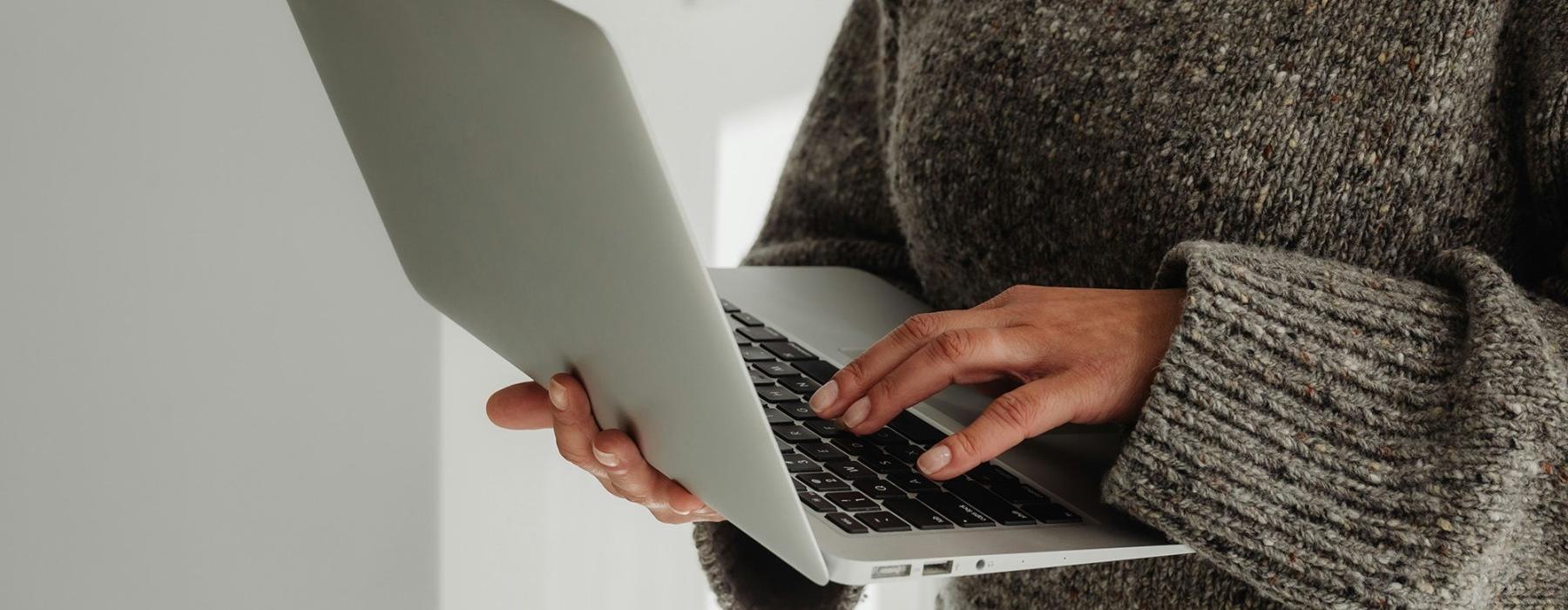 A person holding a laptop.
