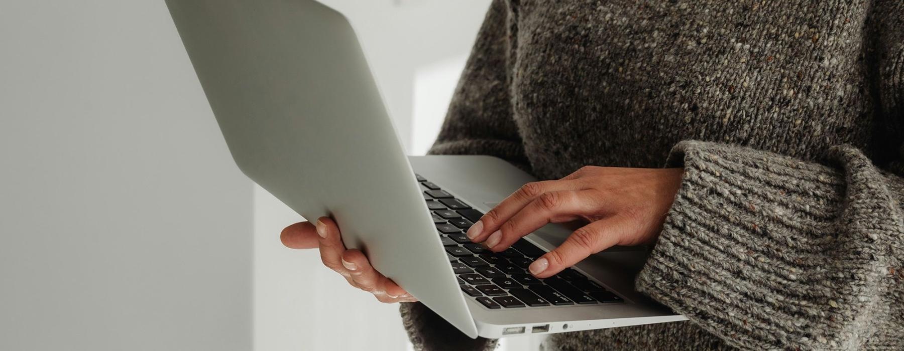 A person holding a laptop.
